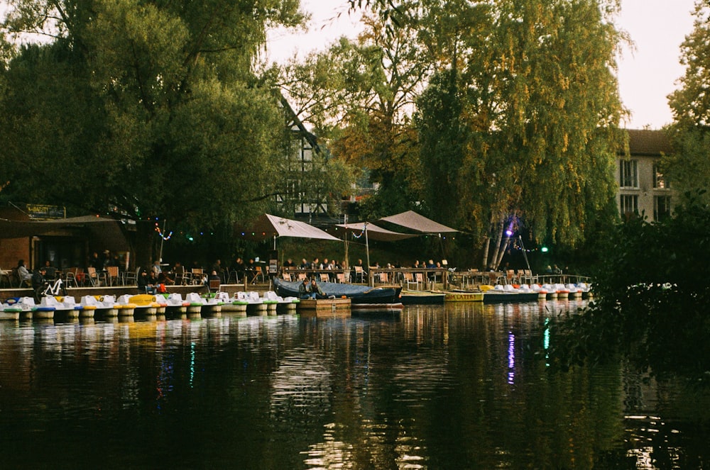 a body of water with boats on it and trees around it