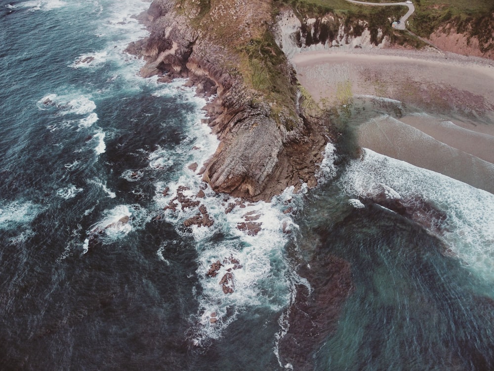 a rocky beach with a body of water