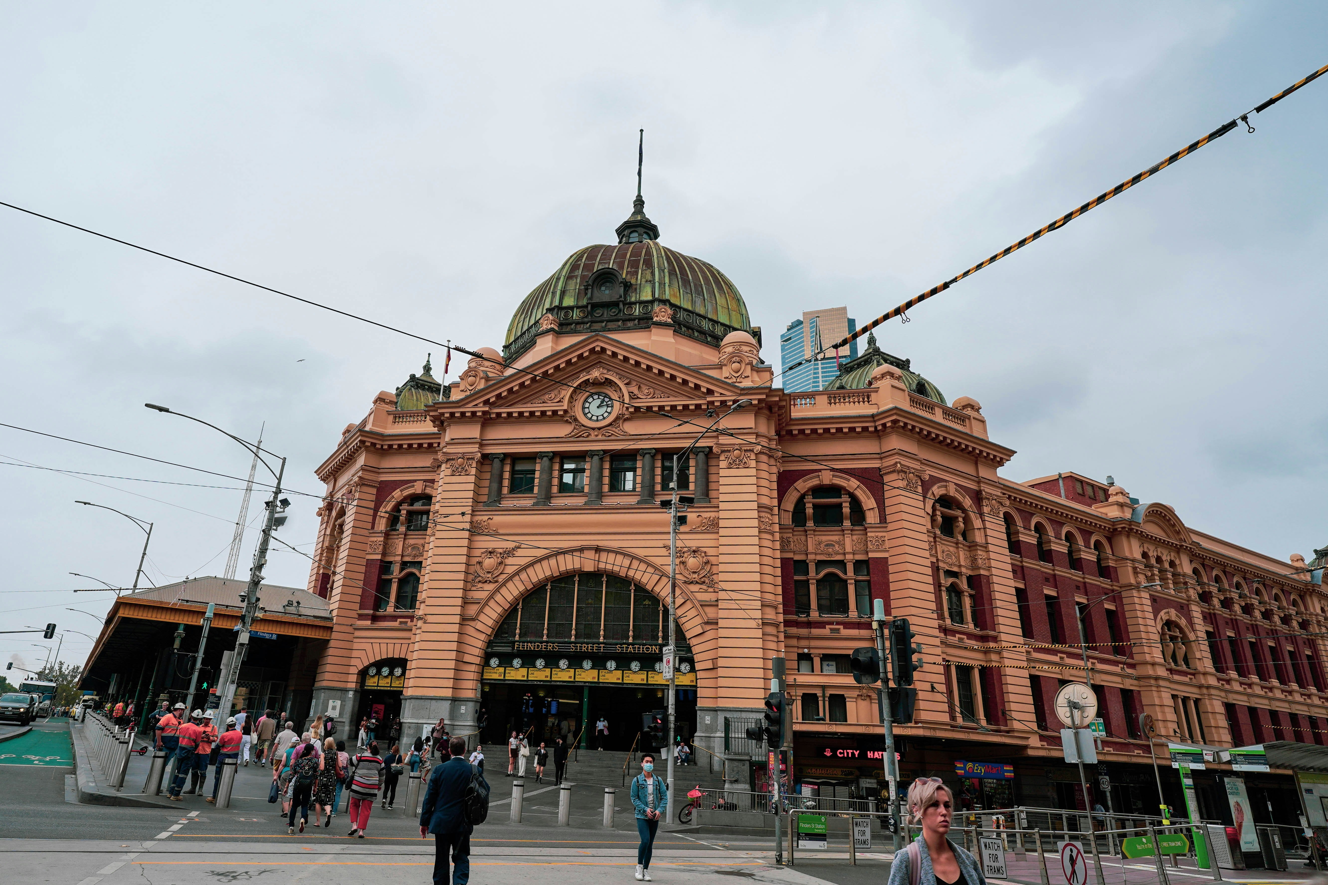 a large building with a dome on top with Flinders Street railway station in the background