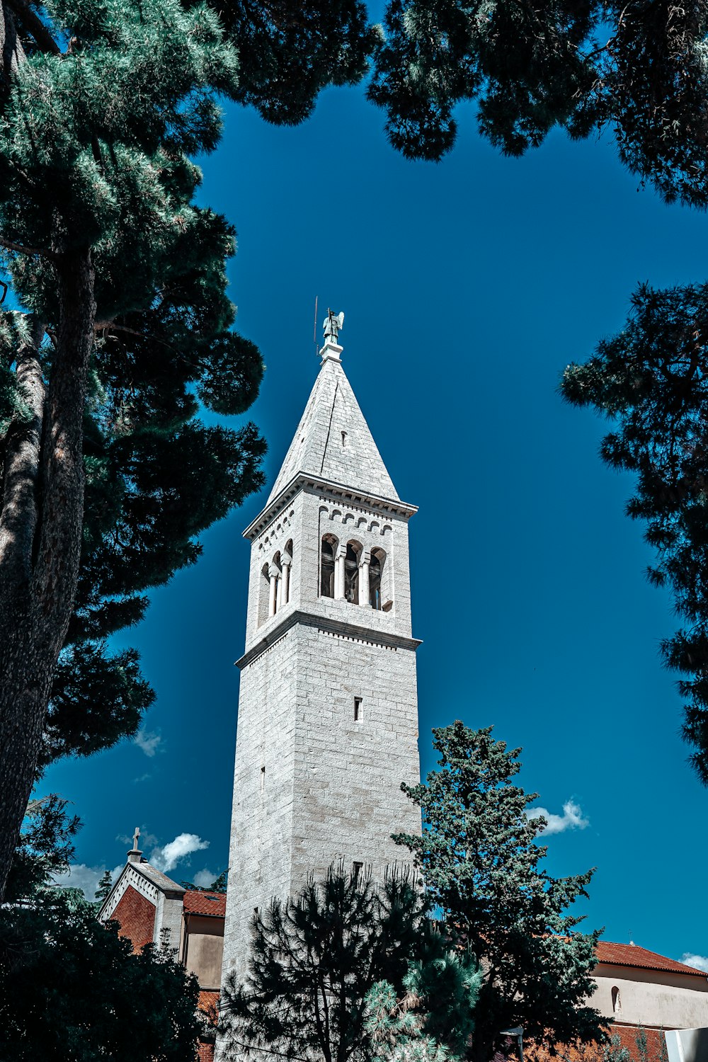 a tall white building with a cross on top