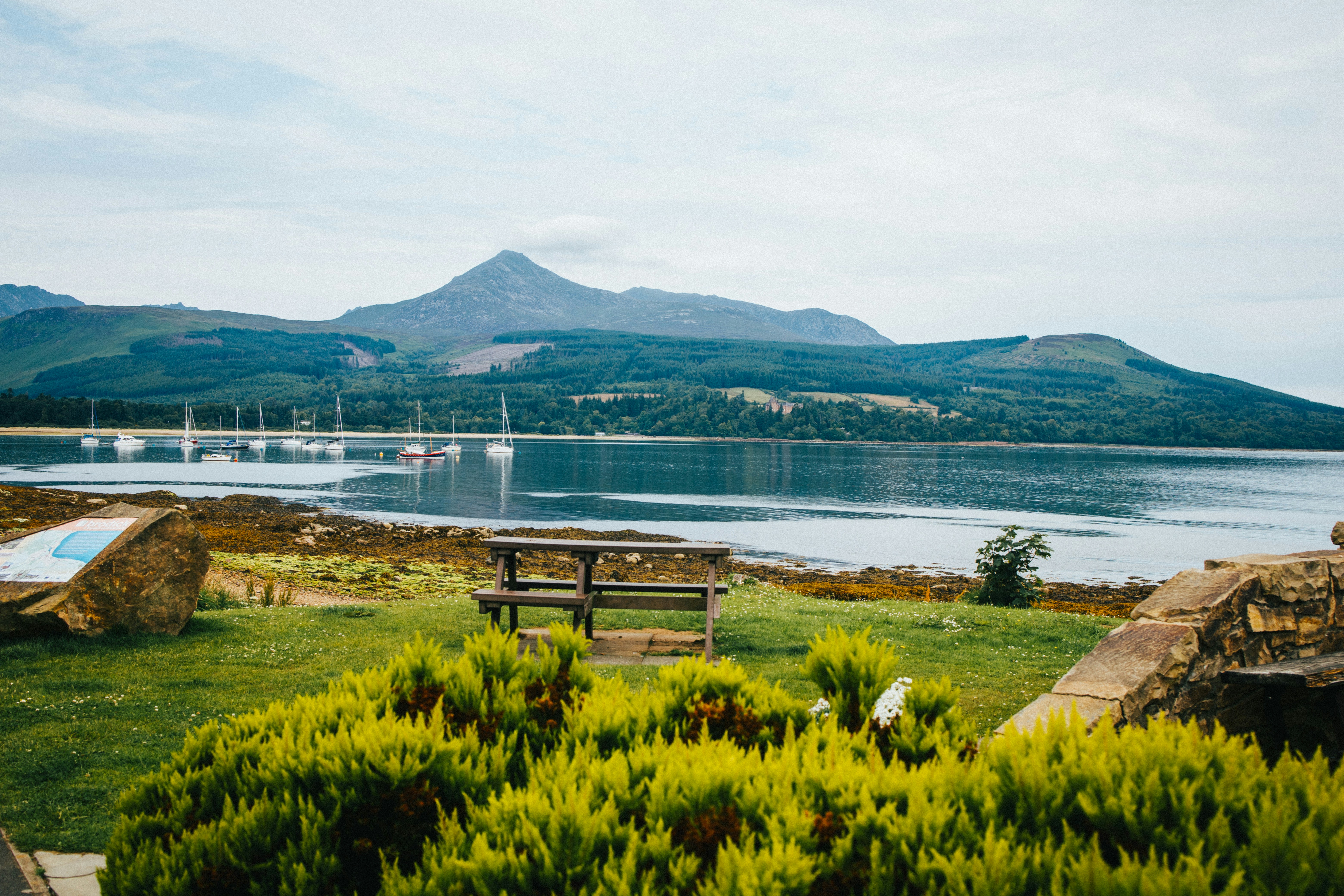 A bench sits by a lake photo – Free Glen rosa Image on Unsplash