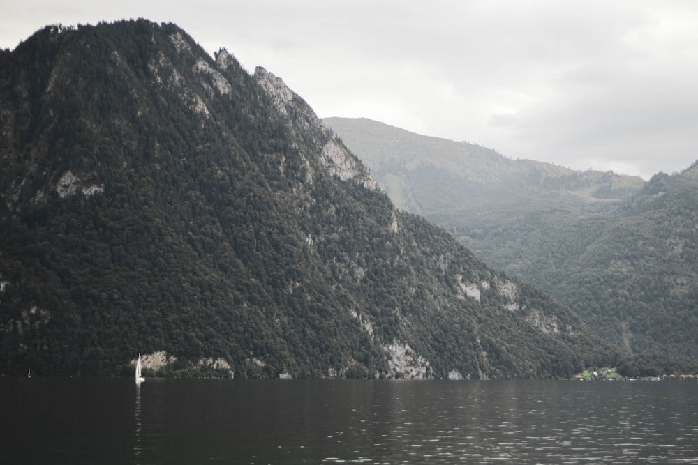 a body of water with mountains in the back