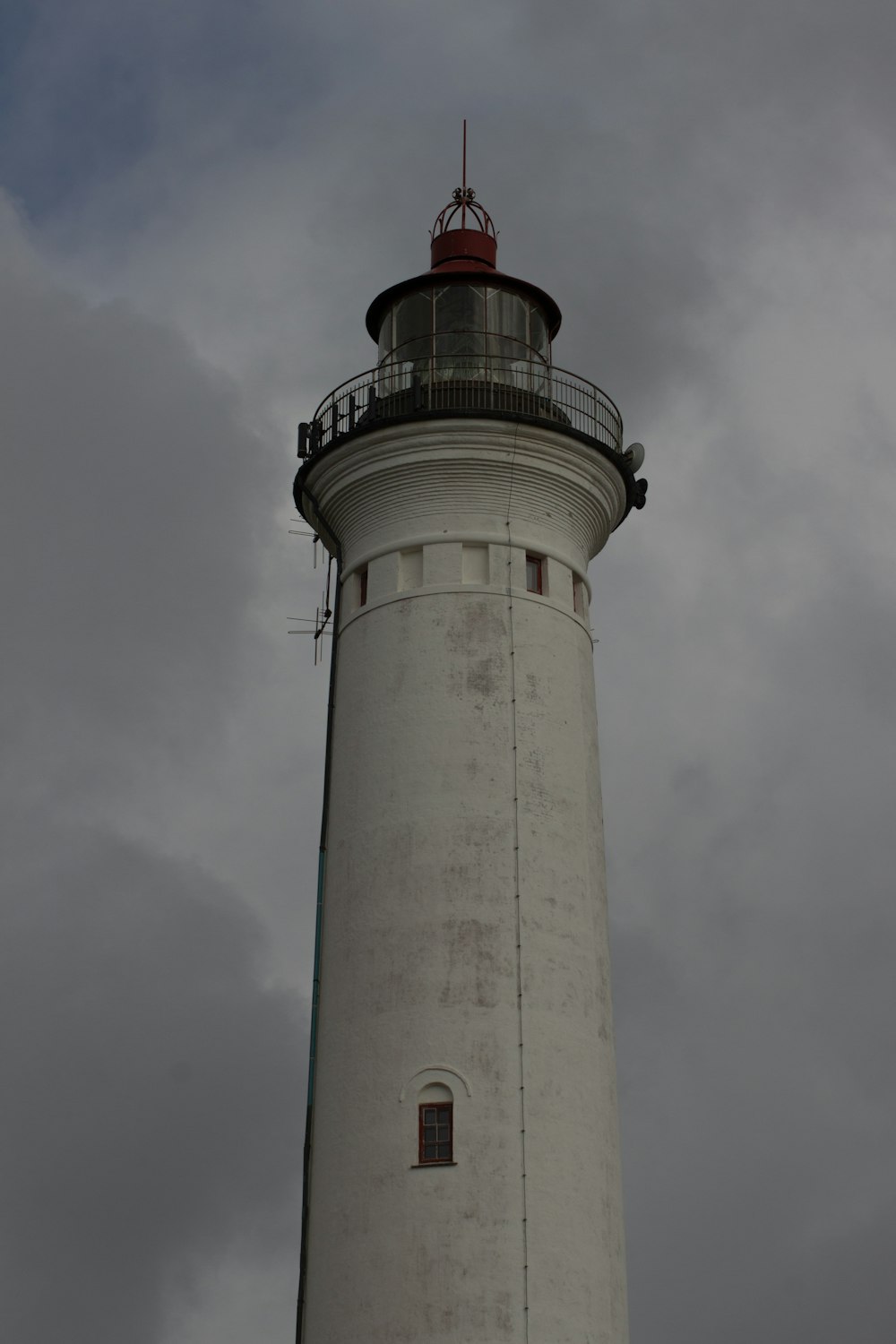 a white tower with a red top