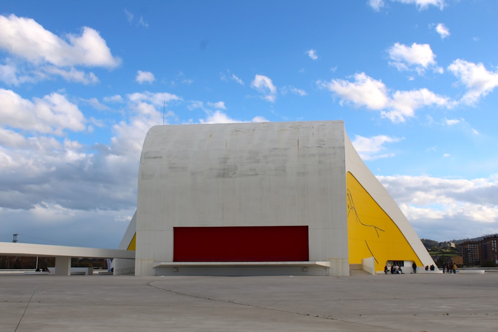 a large white building with a red and yellow sign in front of it