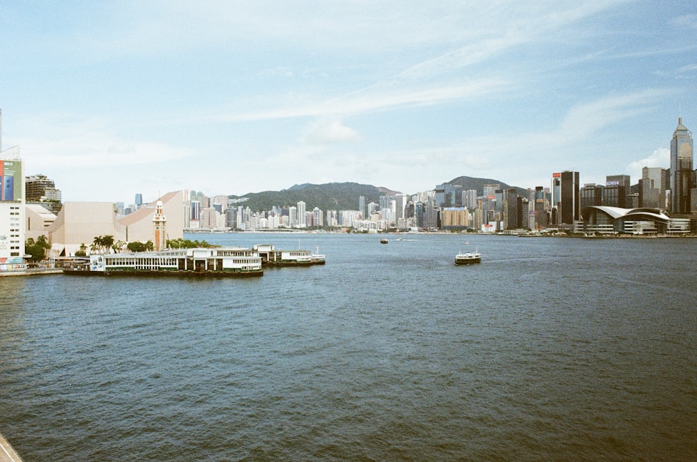 a body of water with boats in it and buildings in the back