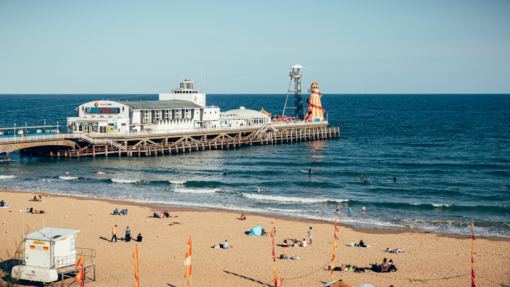 a pier with people on it next to a large body of water