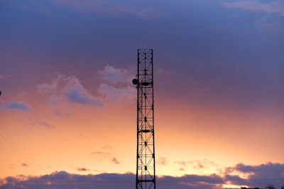 a tower with a sunset in the background