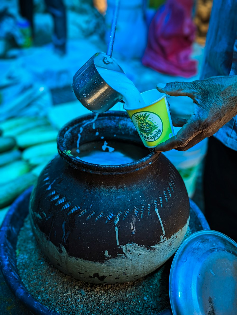 a black teapot with a green label on it