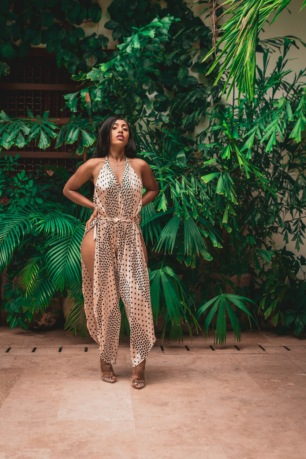 a person in a dress standing in front of a tree