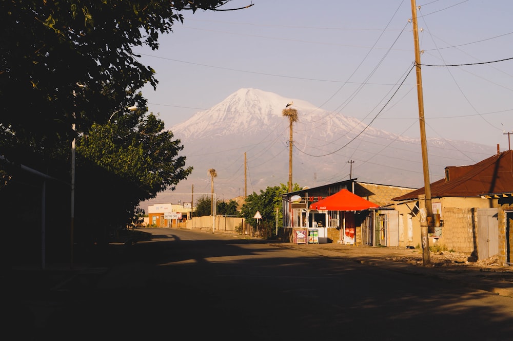 a street with buildings and a mountain in the background