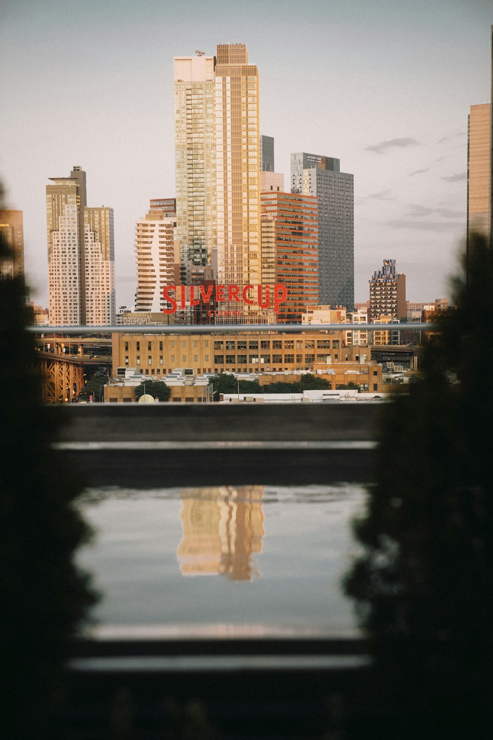 a city skyline with a body of water in front of it