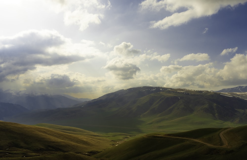 a landscape with hills and clouds