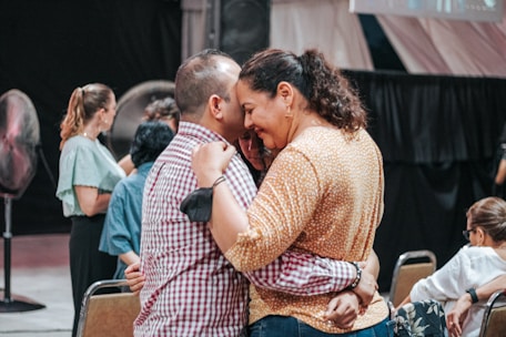 A group of people warmly interacting in a community meeting.