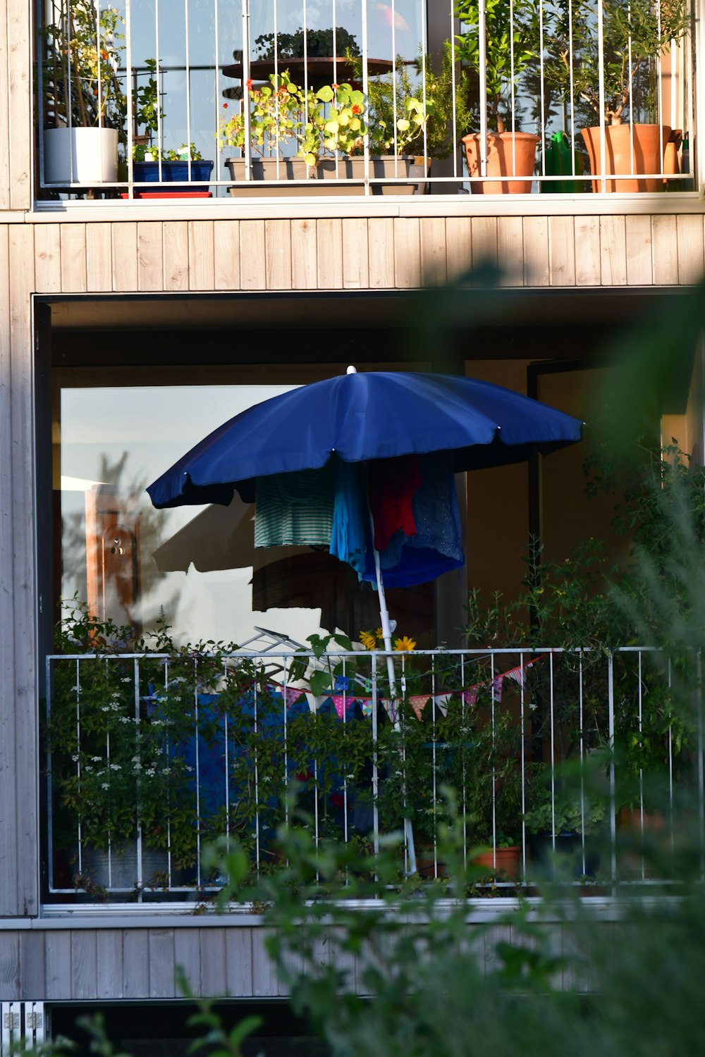 a blue umbrella on a balcony