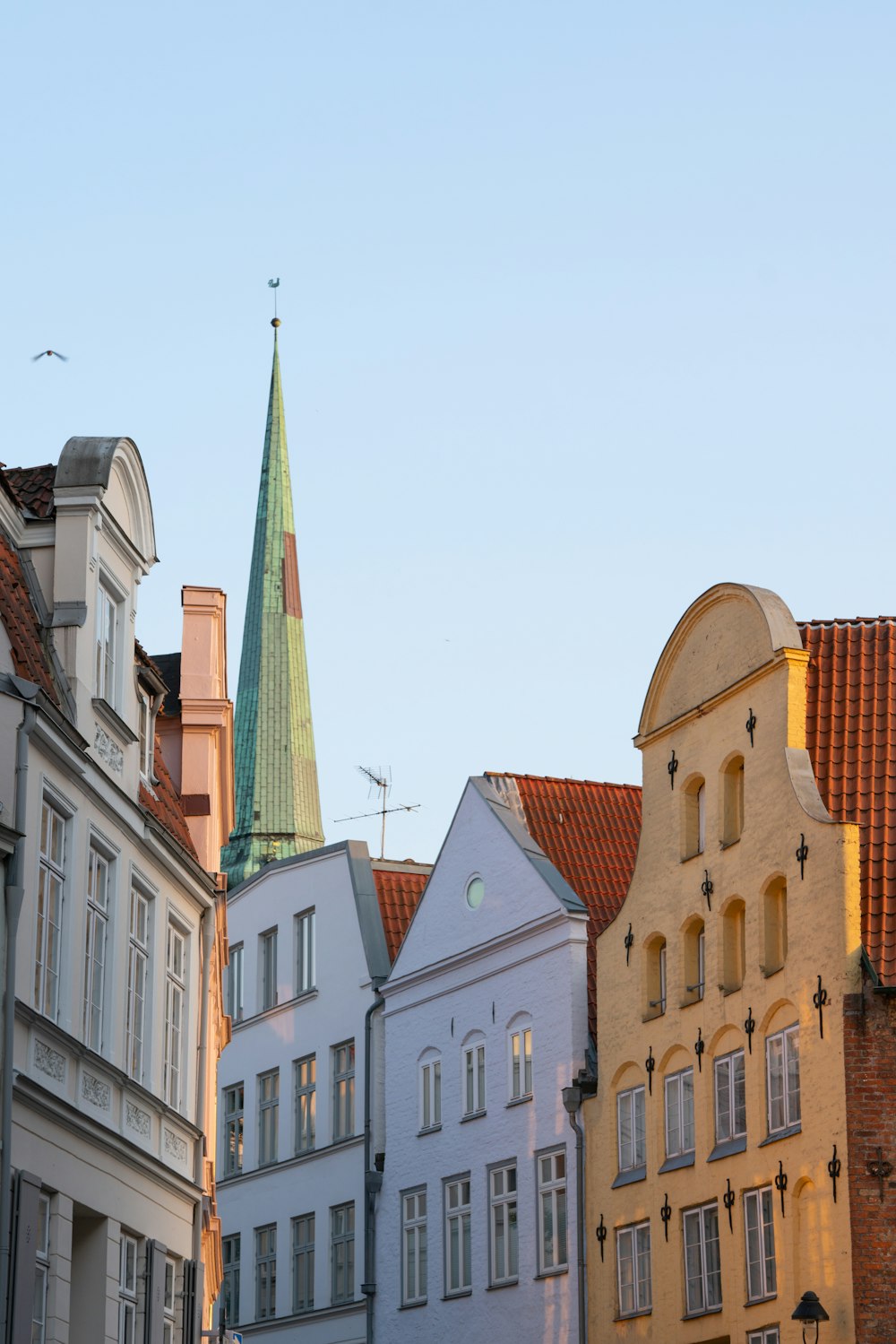 a group of buildings with a green steeple