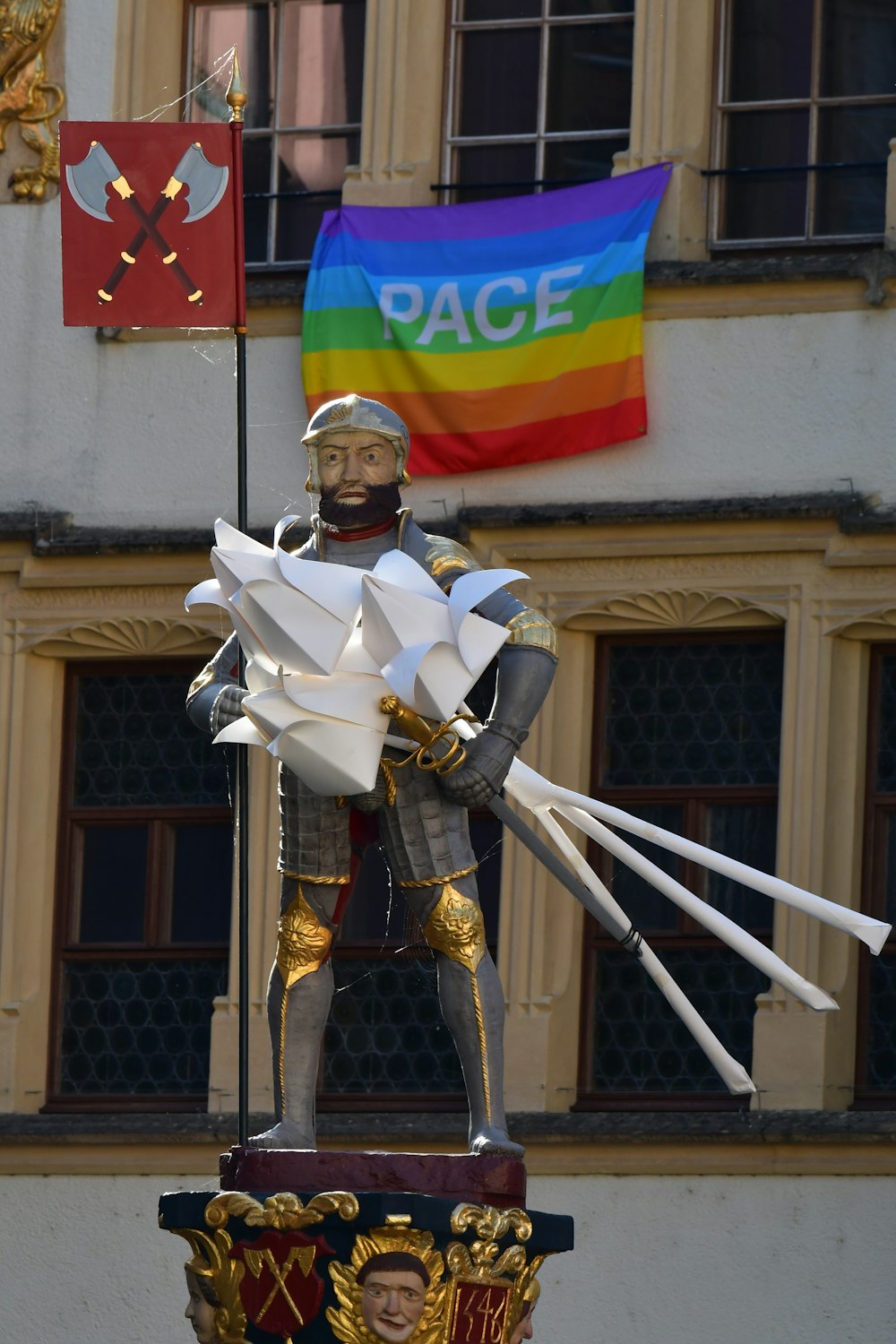a statue of a person holding a flag