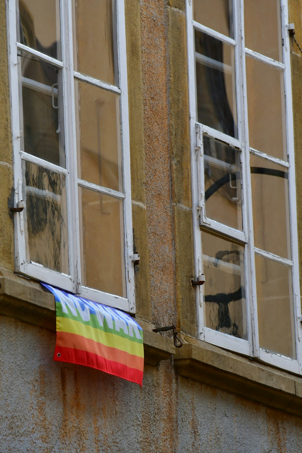 a rainbow flag is from a window