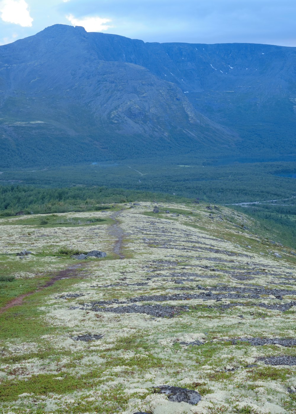 a large mountain with a valley below