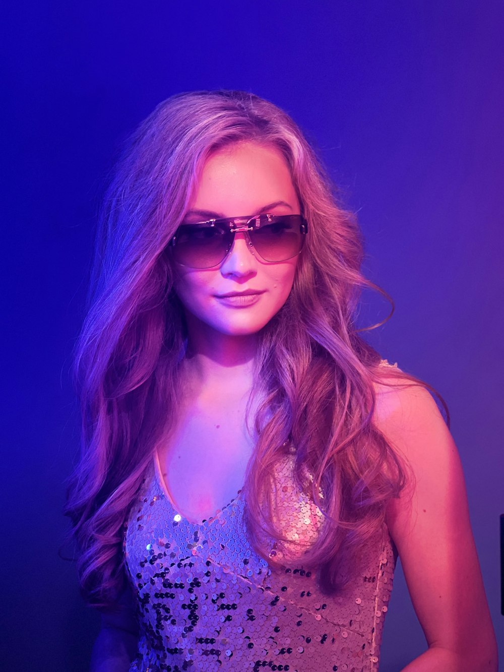 a woman with long hair wearing sunglasses
