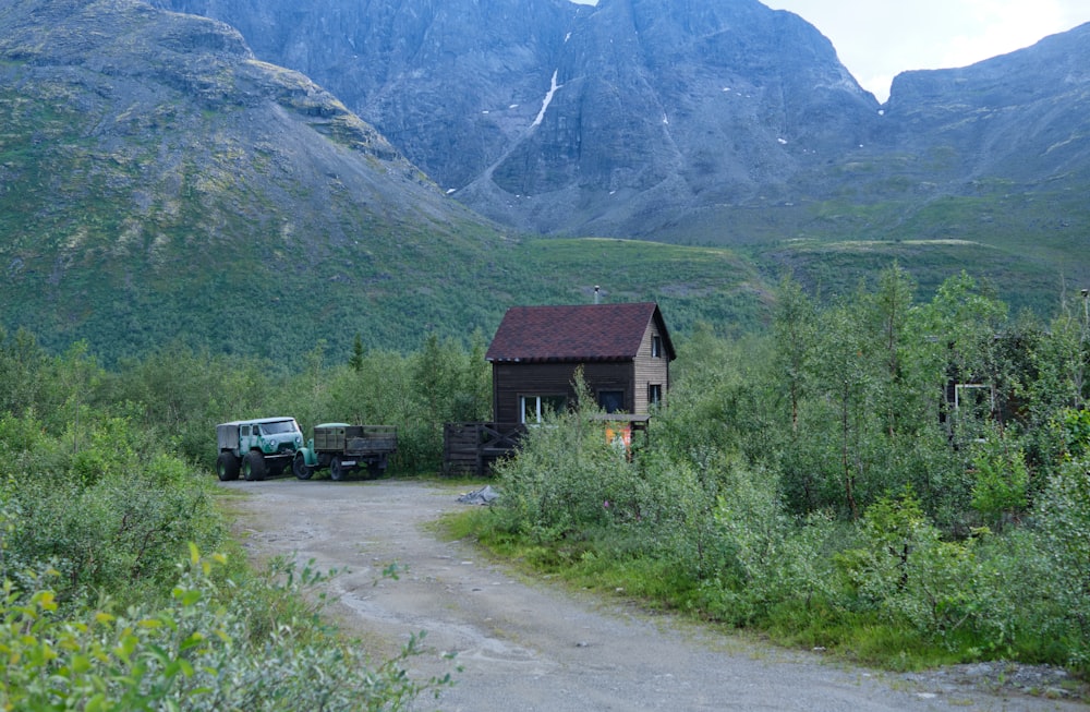 a house on a dirt road in the mountains