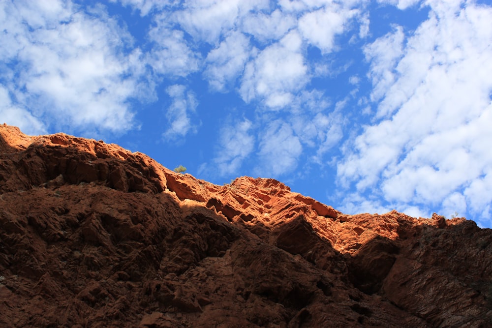 a rocky mountain with clouds