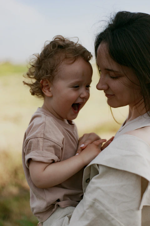 a woman holding a baby