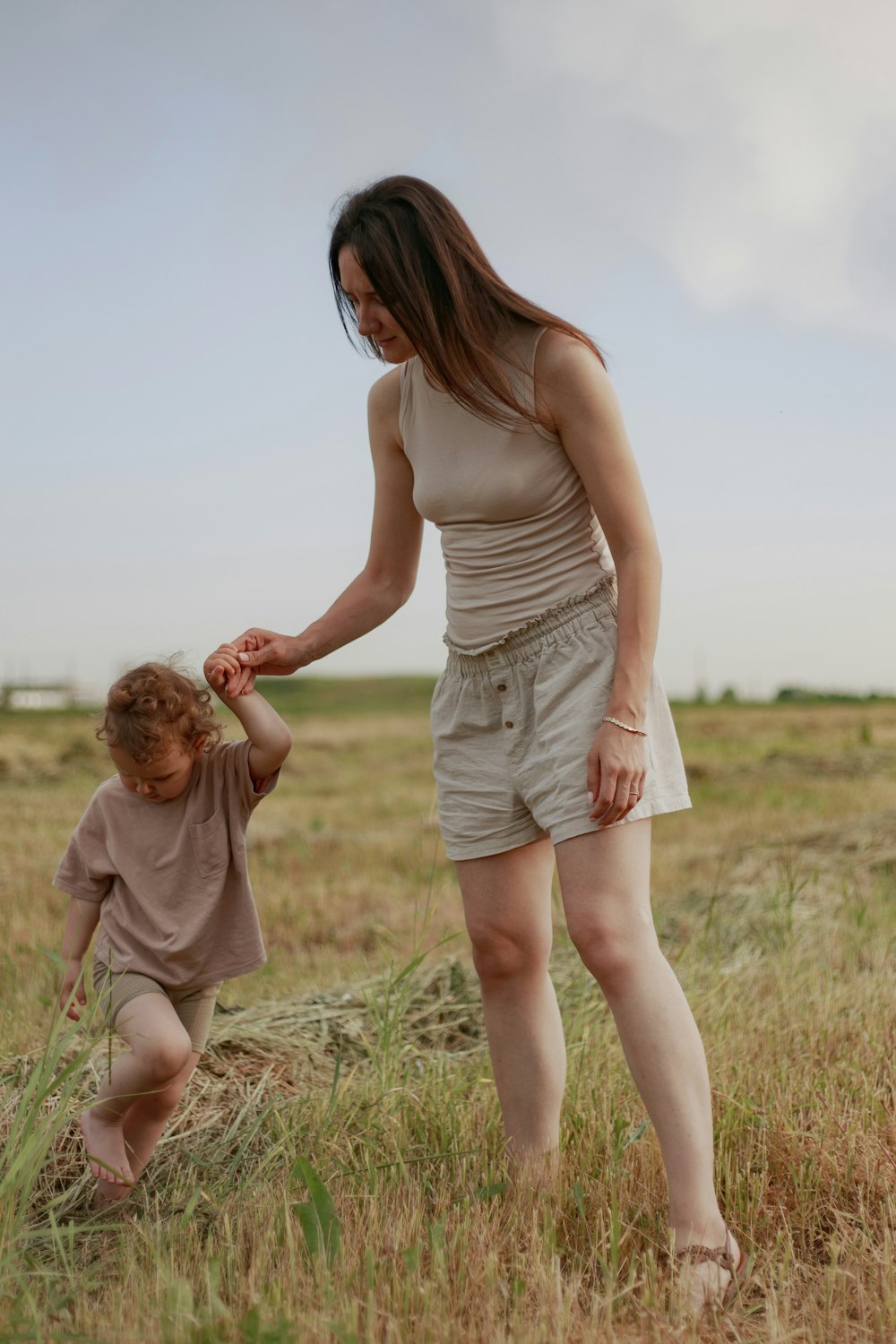 a person and a child walking in a field