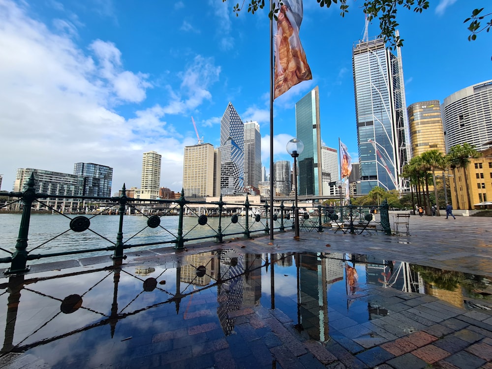 a city skyline with a body of water in front of it