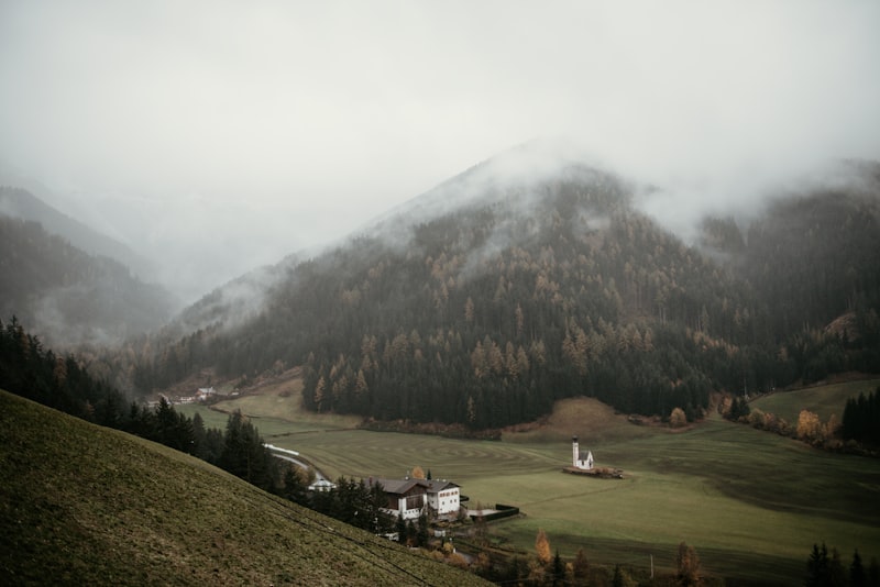 Buildings lining a street in Bolzano with mountain background, South Tyrol