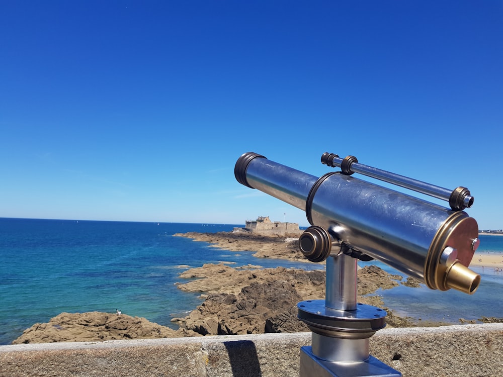 a cannon on a wall overlooking the ocean