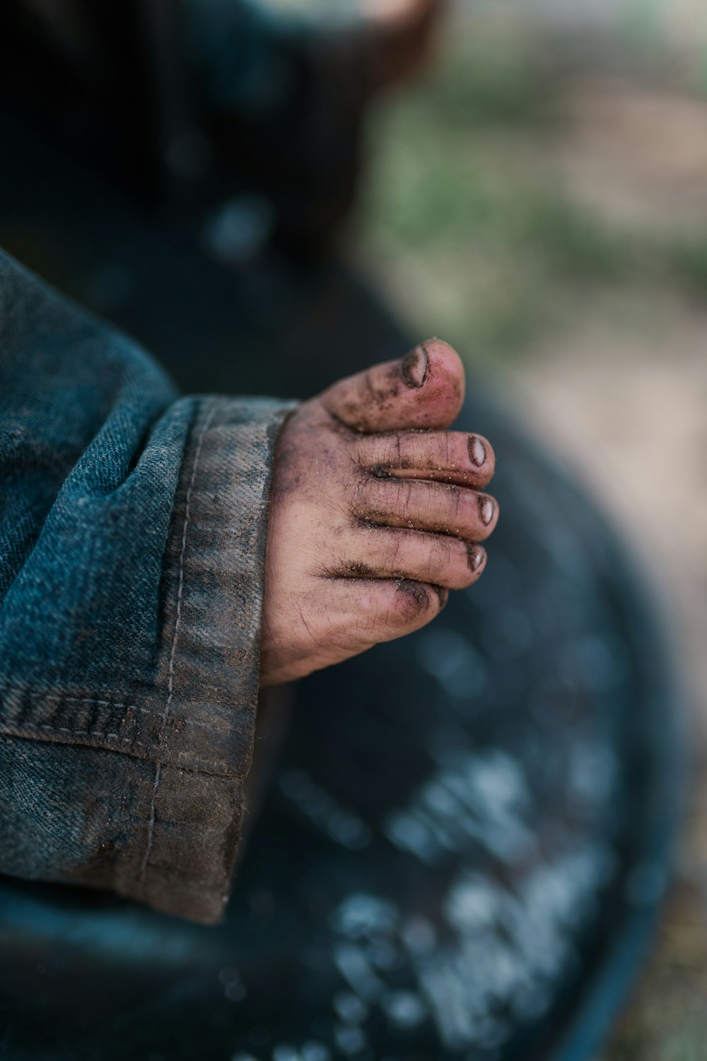 a person's hand on a blue fabric