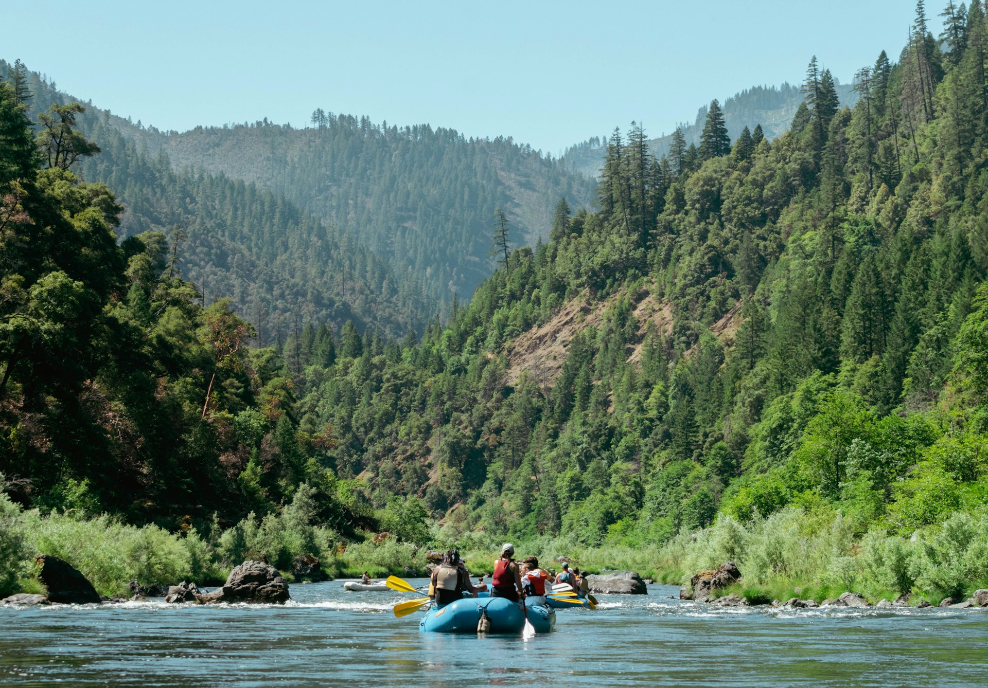 a group of people on a raft in a river