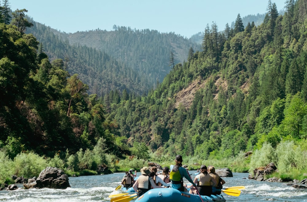 a group of people in a raft on a river