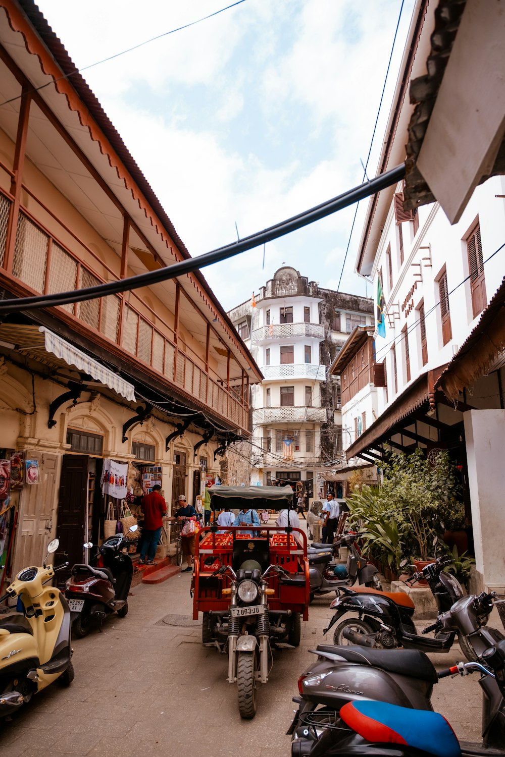 a group of motorcycles parked in a narrow alley