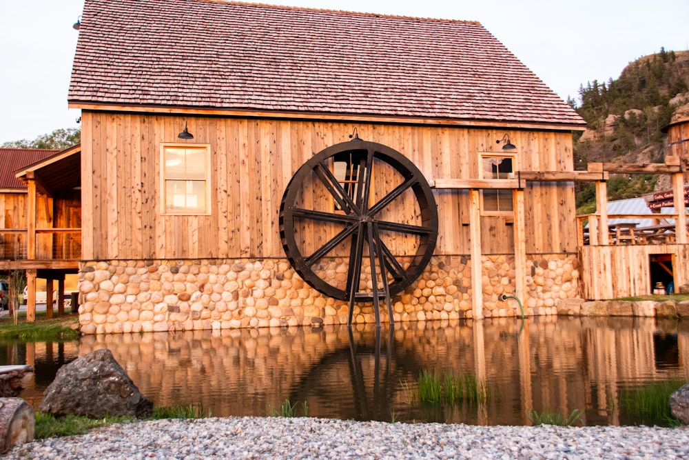 a wooden building with a wheel