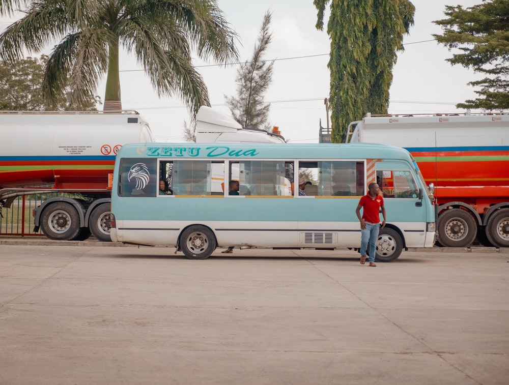 a person standing next to a bus