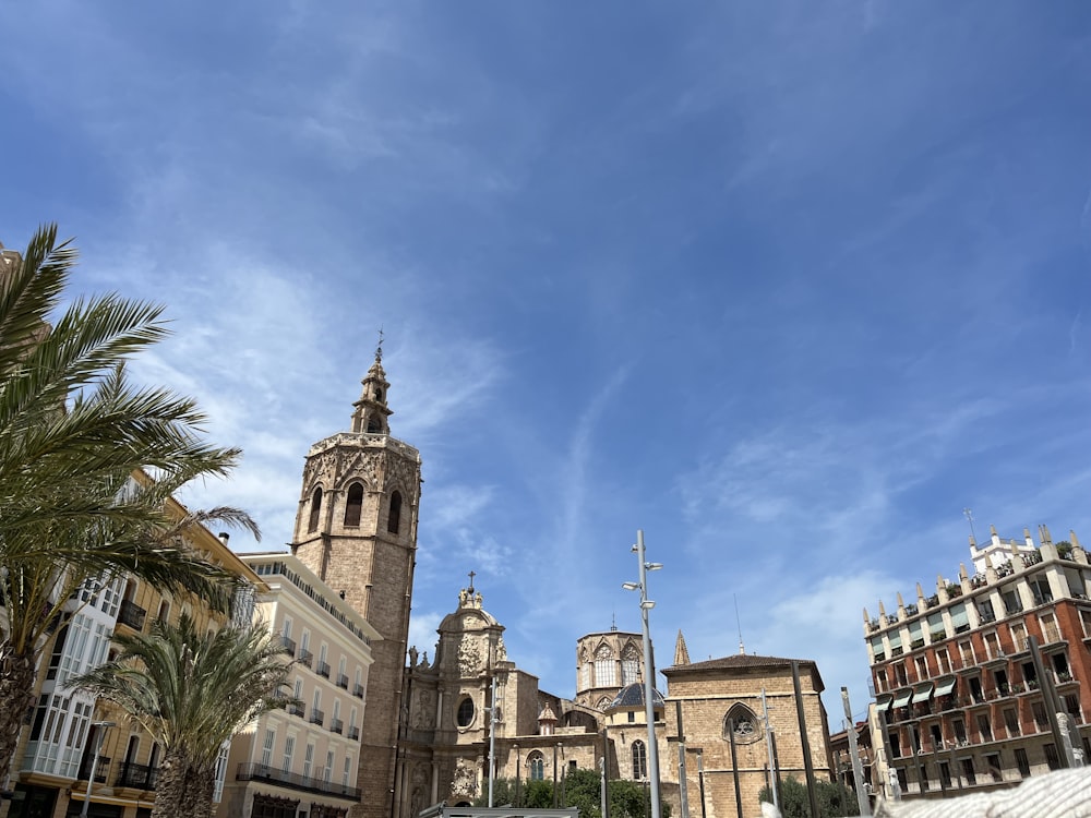 a large building with towers and palm trees