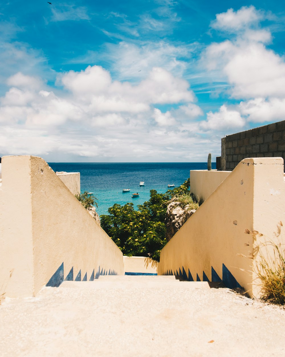 a wall with a body of water in the background