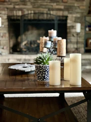 a table with candles and a plant