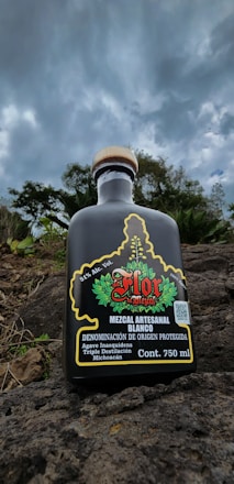 A mezcal distillery with vats releasing vinazas, surrounded by natural landscape emphasizing environmental care.