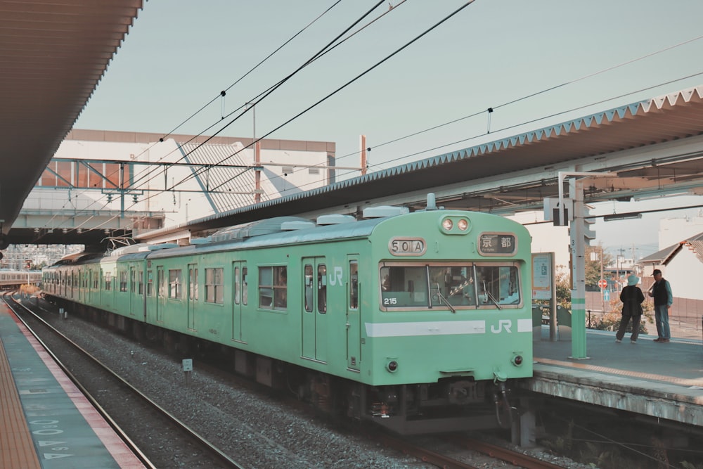 a green train at a train station