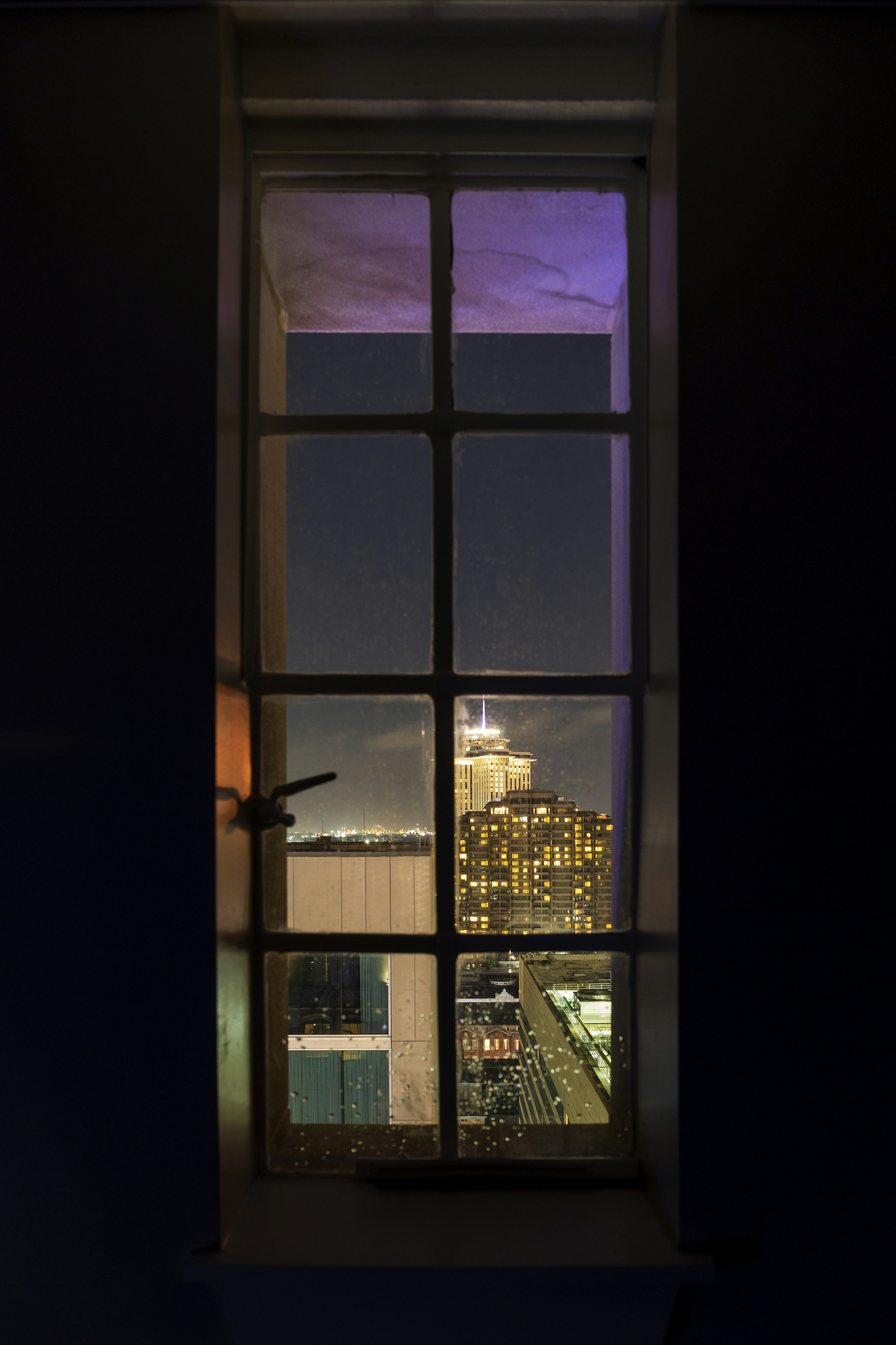 Looking out hotel window.