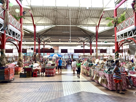 A vibrant local market with various stalls showcasing fresh produce and handmade goods.