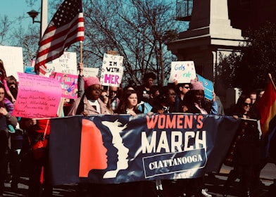 a group of people holding signs and flags