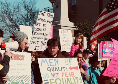 An advocacy event with people holding signs calling for justice and equality.