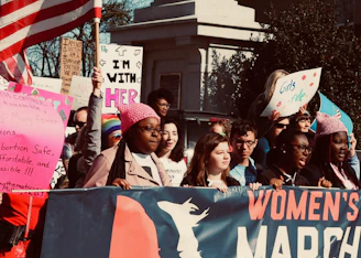 a group of people holding signs and flags