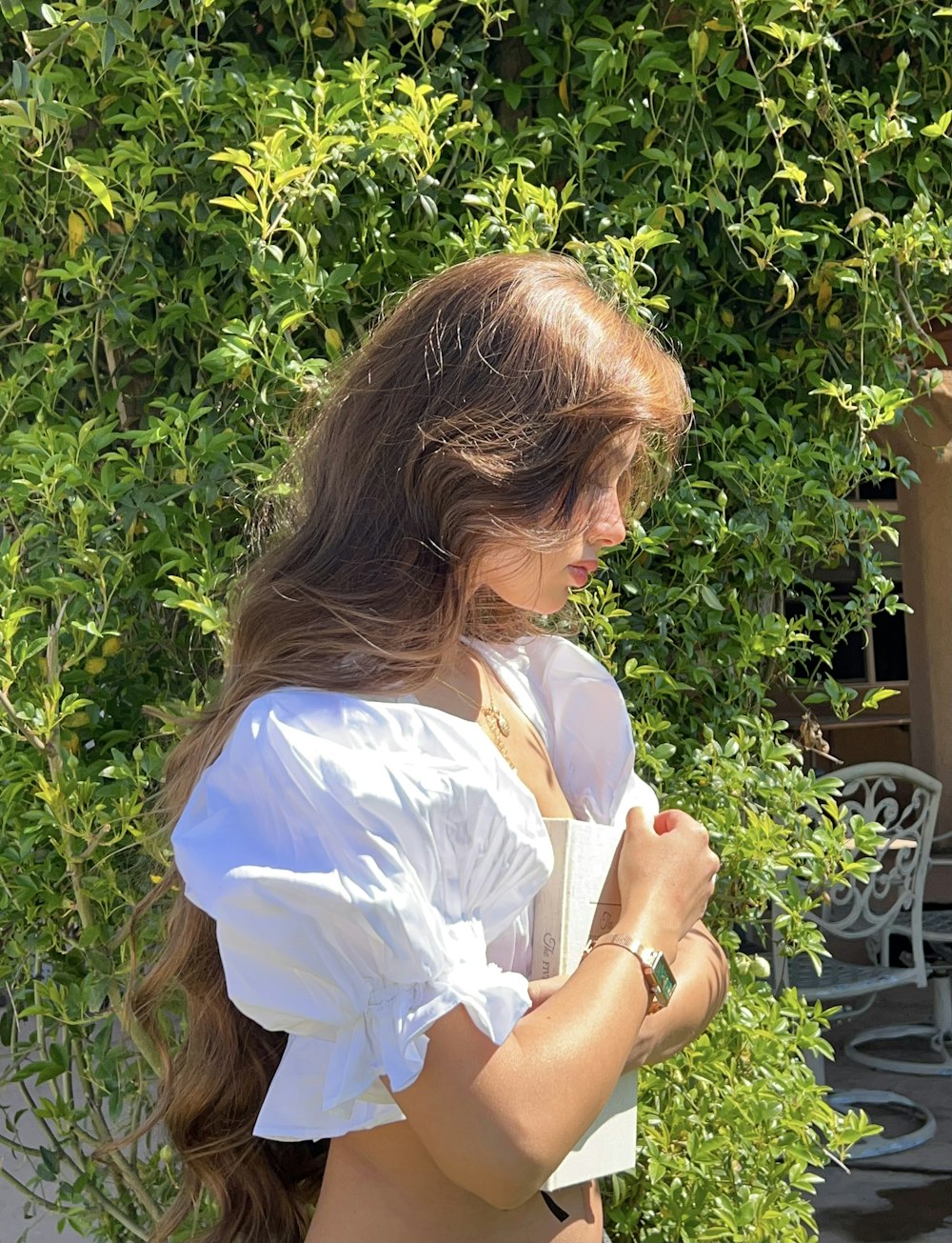 a person sitting outside reading a book