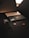 A dark-themed composition feature a smartphone, smartwatch, and a credit card. Each item displays a sleek, modern design, with the phone and smartwatch exhibiting metallic accents, while the credit card has a black matte finish with a prominent MasterCard logo.
