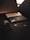 A dark-themed composition feature a smartphone, smartwatch, and a credit card. Each item displays a sleek, modern design, with the phone and smartwatch exhibiting metallic accents, while the credit card has a black matte finish with a prominent MasterCard logo.