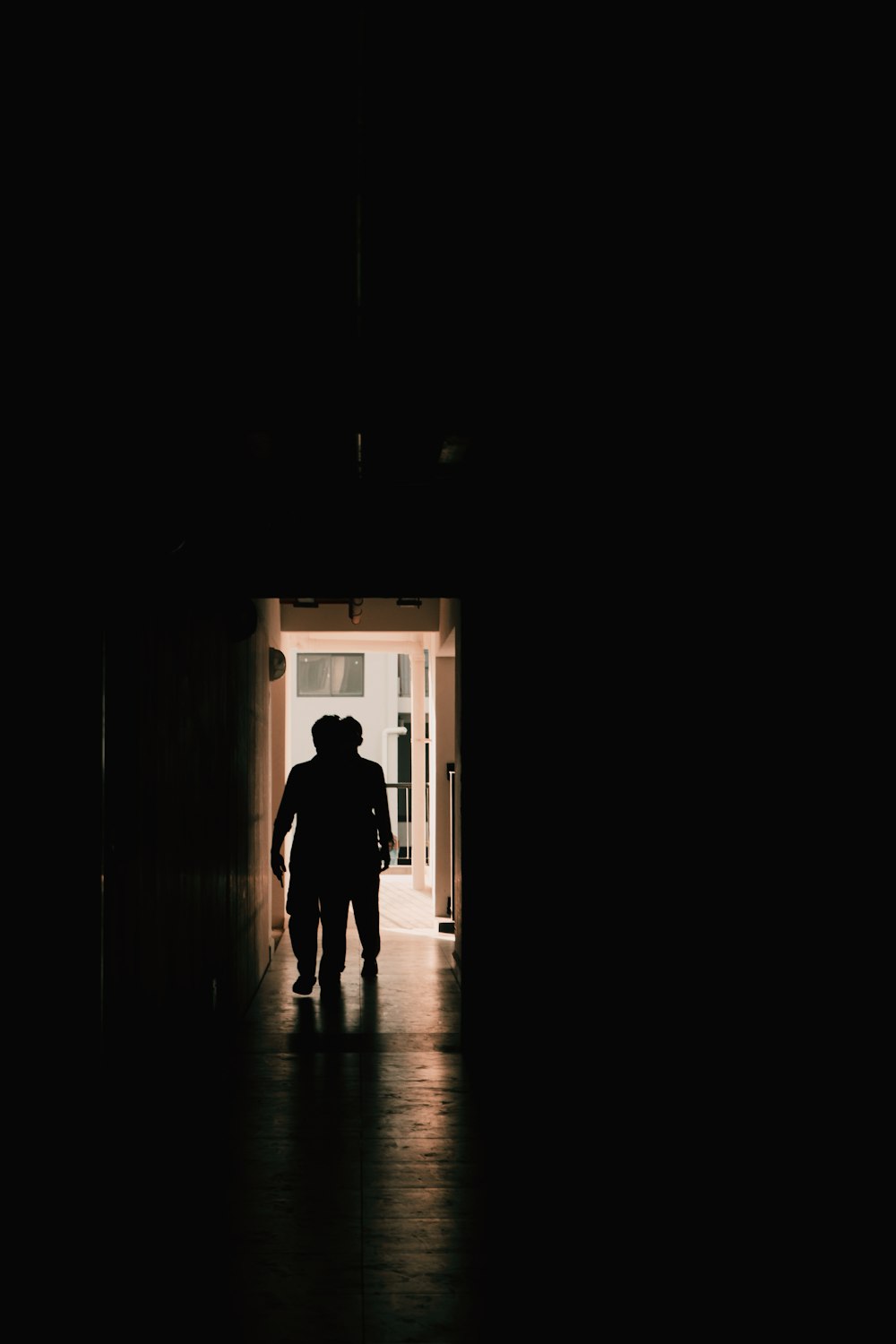 a person walking through a dark hallway